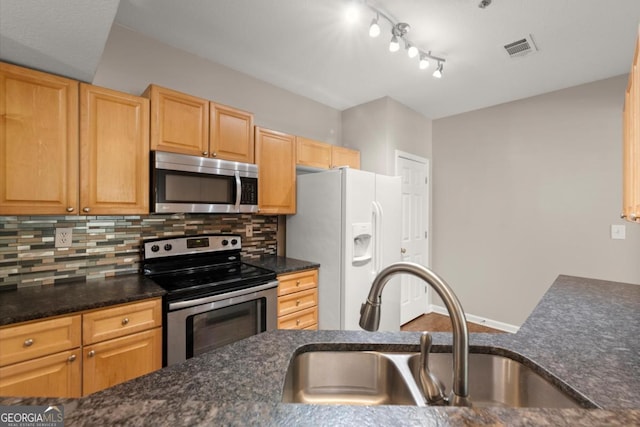 426 Pembrooke Cir Unit 426, Alpharetta, GA 30004 - kitchen featuring appliances with stainless steel finishes, decorative backsplash, dark stone countertops, and light brown cabinets