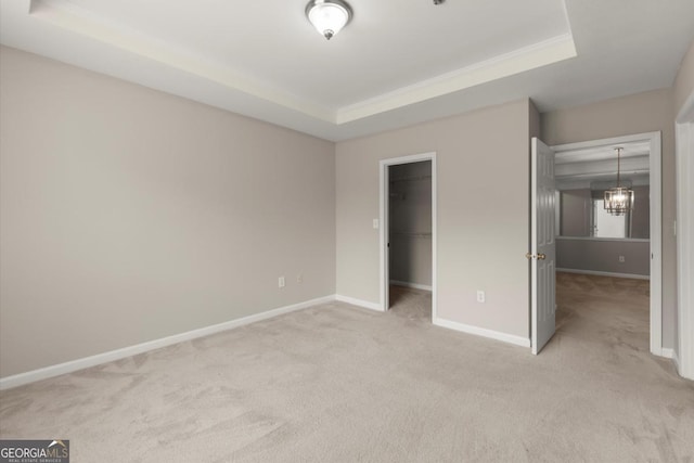 426 Pembrooke Cir Unit 426, Alpharetta, GA 30004 - unfurnished bedroom with a raised ceiling, carpet flooring, a spacious closet, and a closet