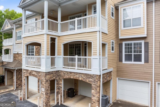 426 Pembrooke Cir Unit 426, Alpharetta, GA 30004 - view of home's exterior with an attached garage, stone siding, and a balcony