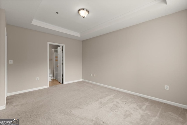 426 Pembrooke Cir Unit 426, Alpharetta, GA 30004 - unfurnished bedroom featuring a raised ceiling, light carpet, and ensuite bathroom