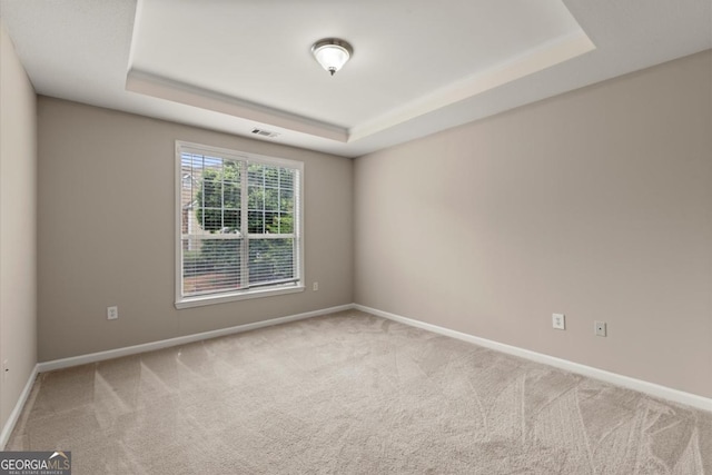 426 Pembrooke Cir Unit 426, Alpharetta, GA 30004 - empty room featuring a tray ceiling and carpet floors