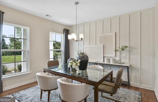 4297 Azalea Ridge Way, Hoschton, GA 30548 - dining space with healthy amount of natural light, a chandelier, and dark wood finished floors