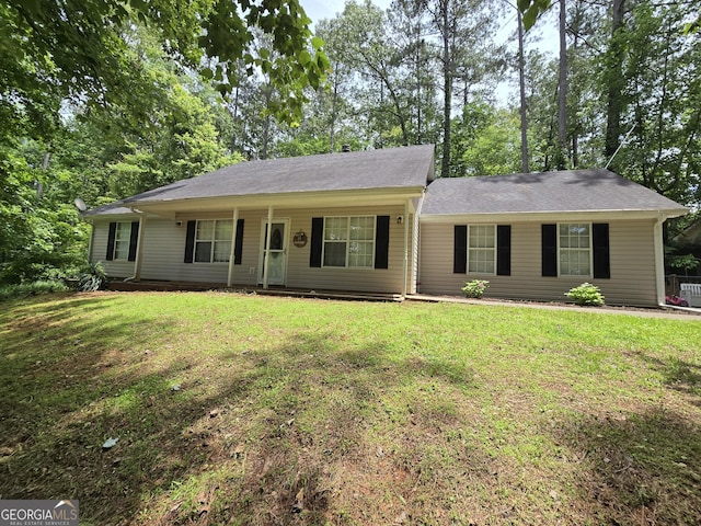 ranch-style home featuring a front yard and covered porch