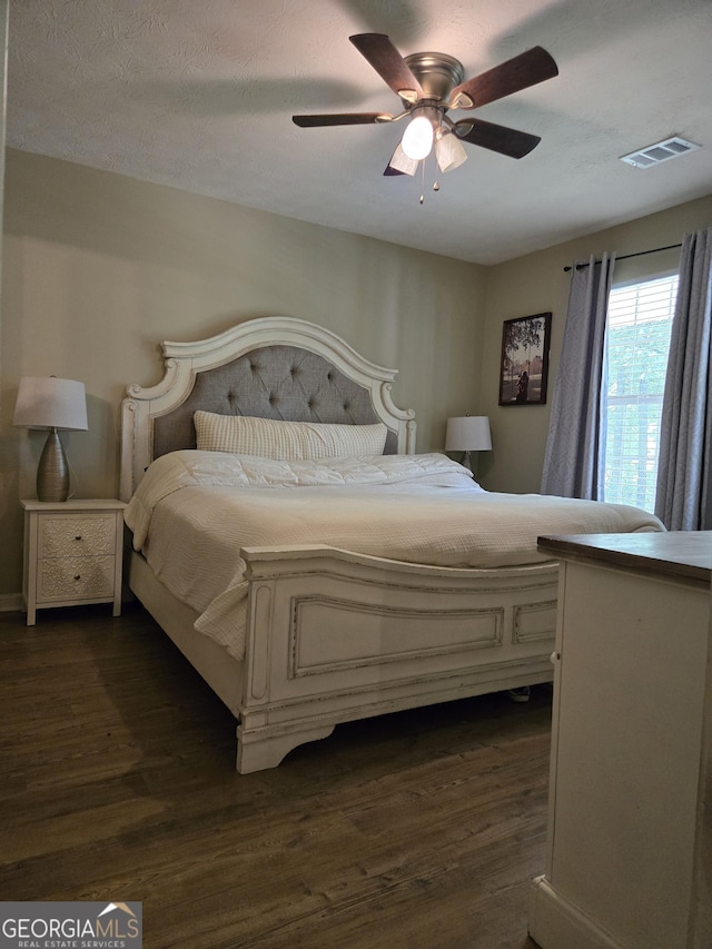 bedroom with dark wood-style flooring and ceiling fan