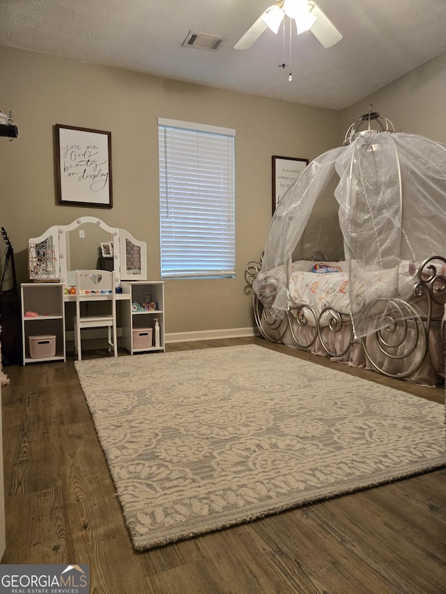 bedroom with wood finished floors, ceiling fan, and baseboards