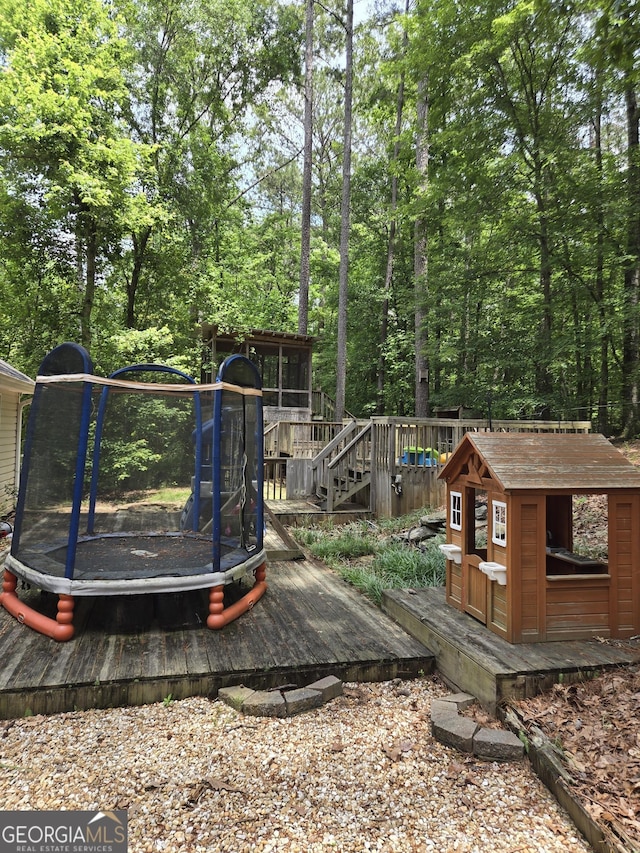 wooden terrace with a trampoline