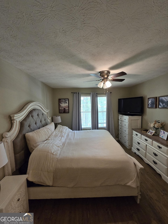 bedroom with wood finished floors, ceiling fan, and a textured ceiling
