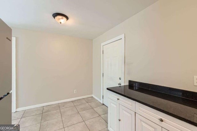 laundry room featuring light tile patterned flooring and baseboards