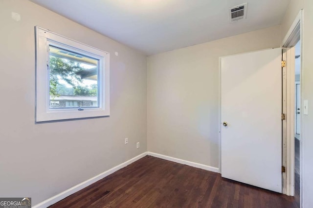 unfurnished bedroom featuring dark wood finished floors and baseboards