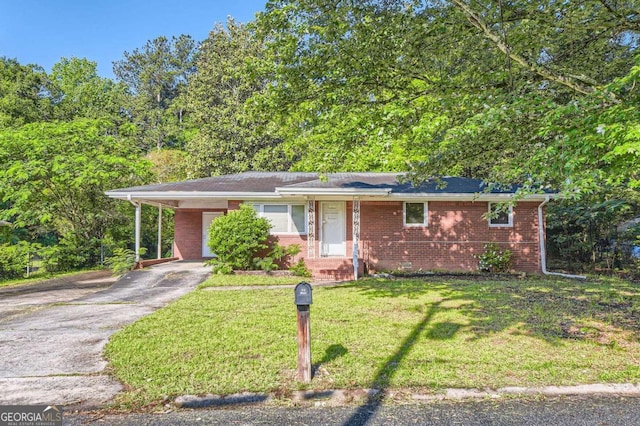 ranch-style home with concrete driveway, a carport, a front yard, and brick siding