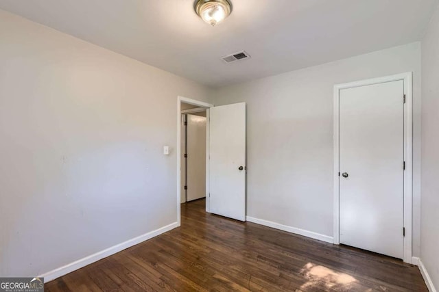 unfurnished bedroom featuring baseboards and wood finished floors