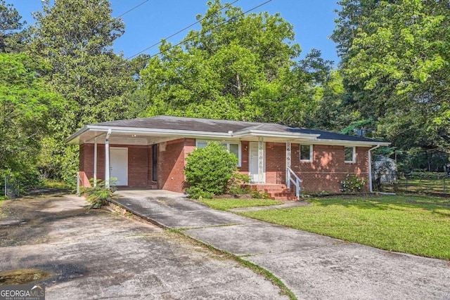 ranch-style house with driveway, brick siding, and a carport