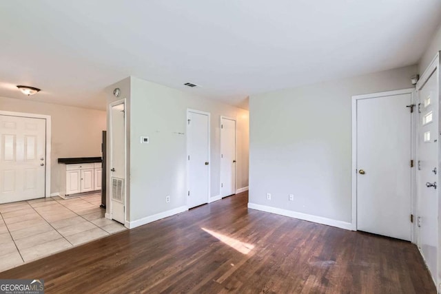 unfurnished room with wood finished floors and baseboards