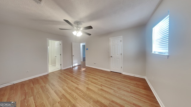 200 Compton Ct, Mcdonough, GA 30252 - unfurnished bedroom featuring light wood-style floors, baseboards, a textured ceiling, ensuite bath, and ceiling fan