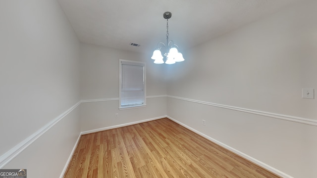 200 Compton Ct, Mcdonough, GA 30252 - unfurnished room featuring light wood finished floors, a chandelier, and baseboards