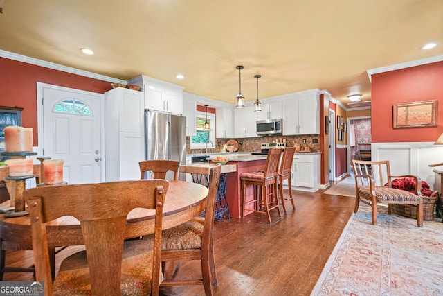 3839 Brookcrest Cir, Decatur, GA 30032 - dining room with crown molding, dark wood-style floors, and recessed lighting
