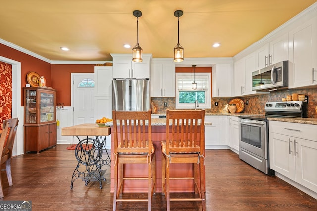 3839 Brookcrest Cir, Decatur, GA 30032 - kitchen featuring stainless steel appliances, crown molding, dark wood-style flooring, white cabinetry, and recessed lighting