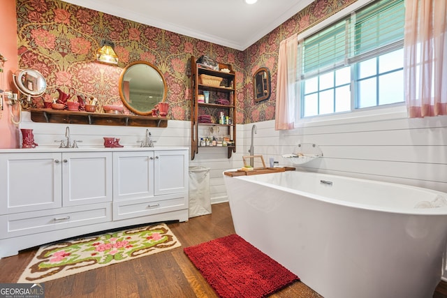 3839 Brookcrest Cir, Decatur, GA 30032 - bathroom with wallpapered walls, ornamental molding, wood finished floors, double vanity, and a freestanding bath