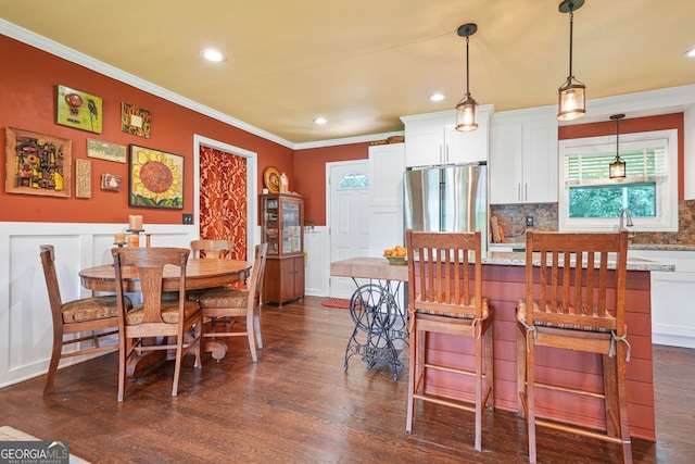3839 Brookcrest Cir, Decatur, GA 30032 - dining room featuring crown molding, dark wood-style floors, a decorative wall, recessed lighting, and wainscoting