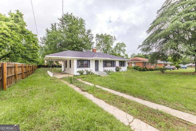 rear view of property with a chimney and an attached carport