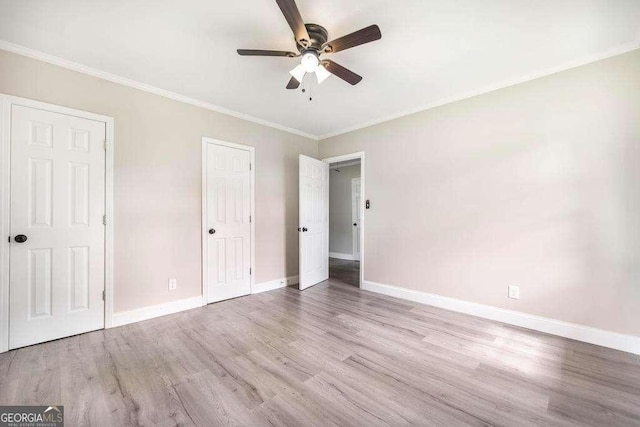 unfurnished bedroom with wood finished floors, baseboards, crown molding, and ceiling fan