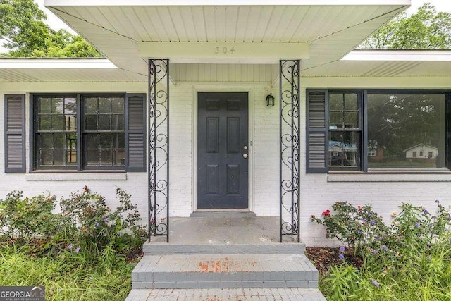 property entrance featuring brick siding