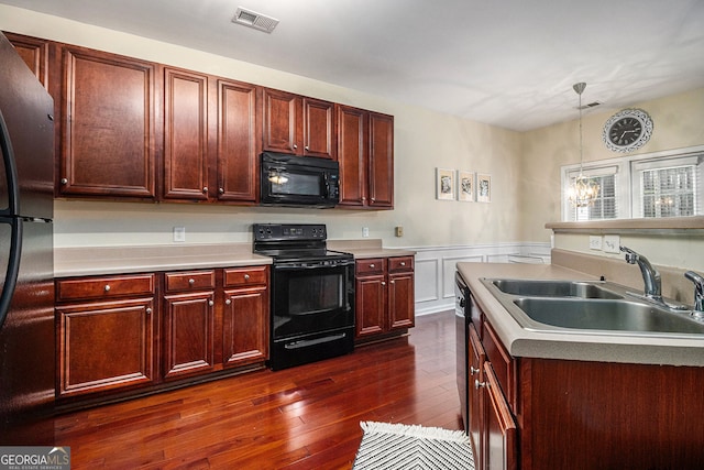 2555 Flat Shoals Rd Unit 1405, College Park, GA 30349 - kitchen featuring black appliances, a sink, dark wood finished floors, light countertops, and wainscoting