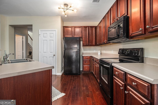 2555 Flat Shoals Rd Unit 1405, College Park, GA 30349 - kitchen with black appliances, a sink, dark wood-type flooring, light countertops, and baseboards