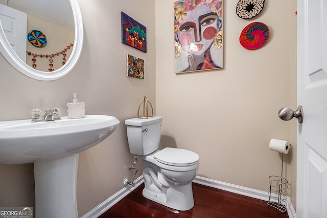 2555 Flat Shoals Rd Unit 1405, College Park, GA 30349 - half bath featuring toilet, baseboards, wood finished floors, and a sink