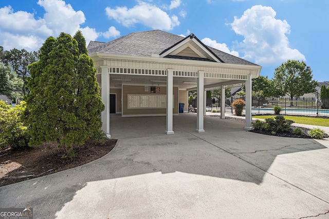 2555 Flat Shoals Rd Unit 1405, College Park, GA 30349 - view of community with a pool, concrete driveway, and an attached carport