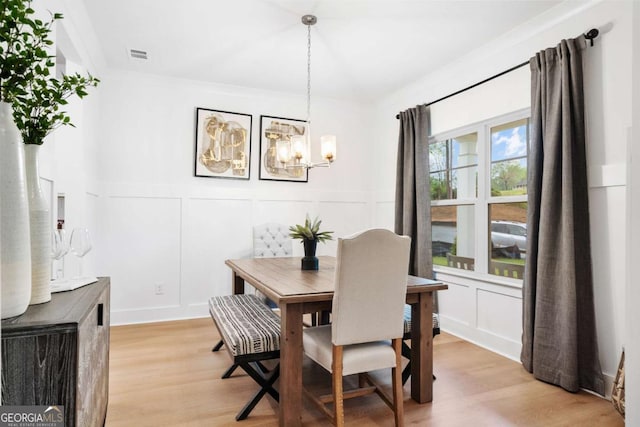 3354 Traditions Way, Jefferson, GA 30549 - dining room with a decorative wall, a chandelier, light wood-style floors, and wainscoting