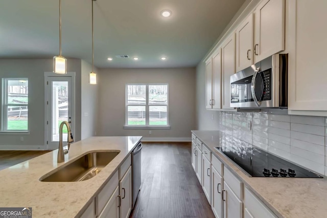 3354 Traditions Way, Jefferson, GA 30549 - kitchen with a sink, appliances with stainless steel finishes, baseboards, dark wood finished floors, and light stone counters