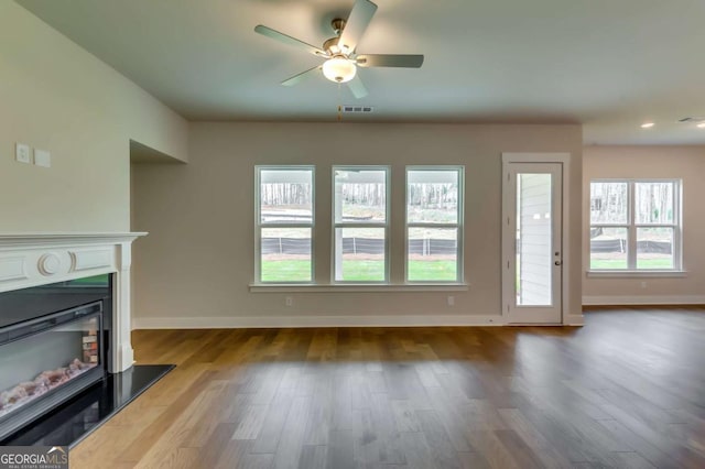 3354 Traditions Way, Jefferson, GA 30549 - unfurnished living room with wood finished floors, baseboards, a glass covered fireplace, and recessed lighting