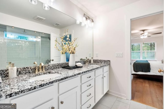 3354 Traditions Way, Jefferson, GA 30549 - ensuite bathroom featuring tile patterned floors, double vanity, a stall shower, a ceiling fan, and baseboards