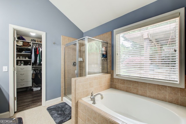 5220 Wild Cedar Dr, Buford, GA 30518 - bathroom with a garden tub, lofted ceiling, a shower stall, and a walk in closet