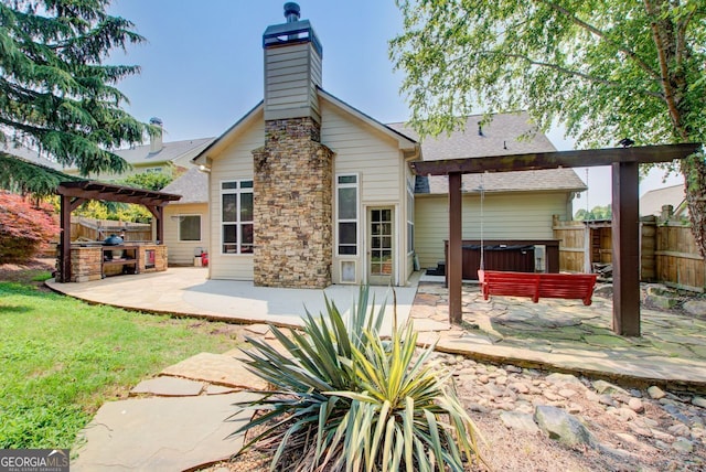 5220 Wild Cedar Dr, Buford, GA 30518 - back of house with a covered hot tub, a patio area, a pergola, and a chimney