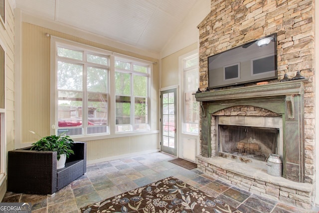 5220 Wild Cedar Dr, Buford, GA 30518 - living area featuring stone tile floors, vaulted ceiling, a fireplace, healthy amount of natural light, and baseboards