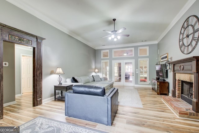 5220 Wild Cedar Dr, Buford, GA 30518 - living room with a ceiling fan, ornamental molding, light wood-style floors, a brick fireplace, and french doors