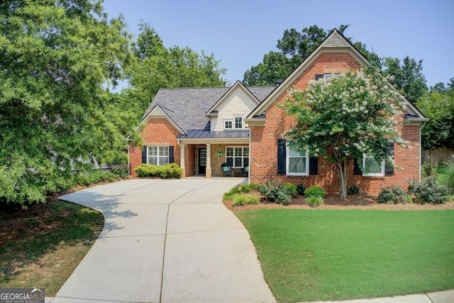 5220 Wild Cedar Dr, Buford, GA 30518 - traditional home featuring brick siding, a standing seam roof, a front lawn, concrete driveway, and metal roof
