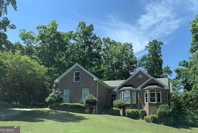 view of front facade featuring a front lawn and brick siding