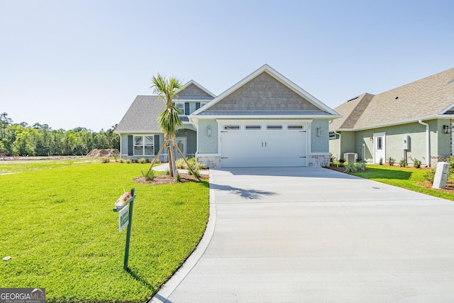 137 Amanda Trce, Kingsland, GA 31548 - craftsman house featuring concrete driveway, a garage, a front lawn, and stone siding