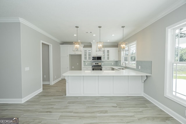 137 Amanda Trce, Kingsland, GA 31548 - kitchen with stainless steel appliances, light countertops, a peninsula, white cabinets, and glass insert cabinets