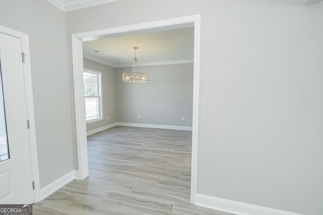 137 Amanda Trce, Kingsland, GA 31548 - empty room featuring ornamental molding, baseboards, a chandelier, and light wood-type flooring