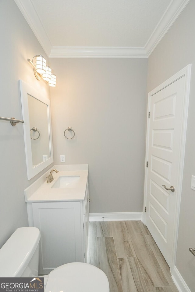 137 Amanda Trce, Kingsland, GA 31548 - bathroom with ornamental molding, toilet, vanity, wood finished floors, and baseboards