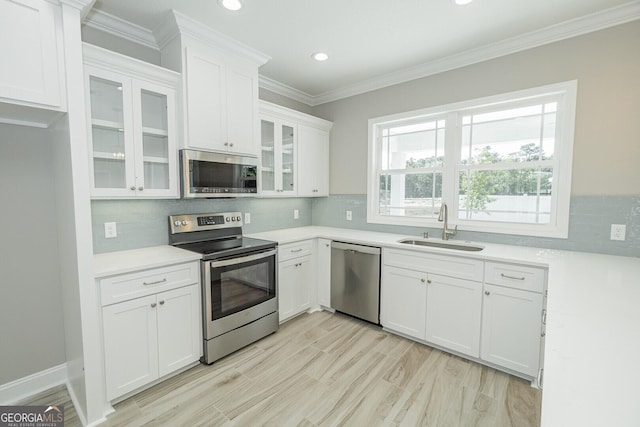 137 Amanda Trce, Kingsland, GA 31548 - kitchen featuring stainless steel appliances, a sink, white cabinetry, light countertops, and decorative backsplash