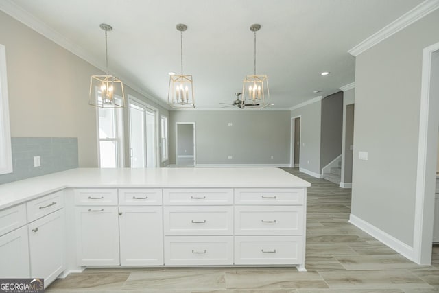 137 Amanda Trce, Kingsland, GA 31548 - kitchen with a chandelier, ornamental molding, a peninsula, white cabinetry, and light countertops
