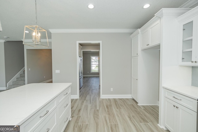 137 Amanda Trce, Kingsland, GA 31548 - kitchen with crown molding, white cabinetry, a chandelier, light countertops, and stainless steel fridge