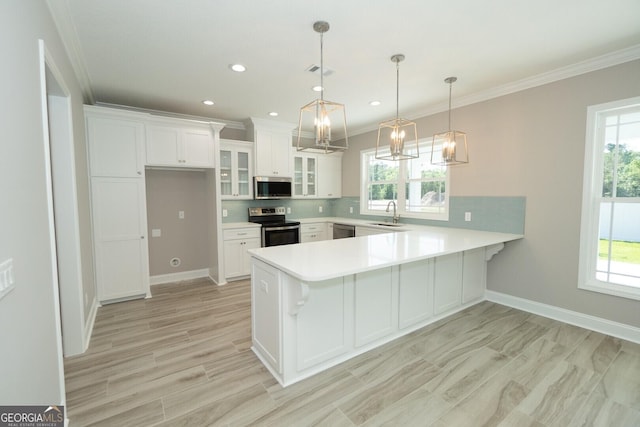 137 Amanda Trce, Kingsland, GA 31548 - kitchen featuring stainless steel appliances, a peninsula, glass insert cabinets, light countertops, and tasteful backsplash
