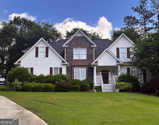 74 Flanders Ct, Douglasville, GA 30134 - view of front of home with stone siding, a front lawn, roof with shingles, and a standing seam roof