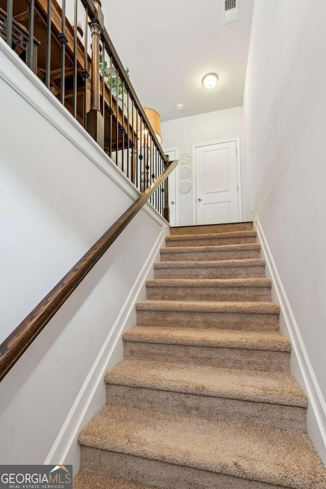 stairway featuring baseboards